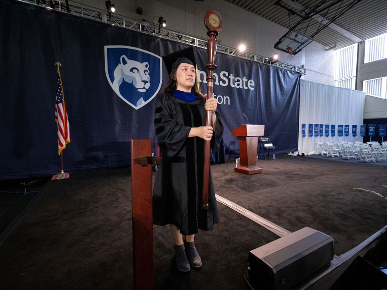 person standing on commencement stage 
