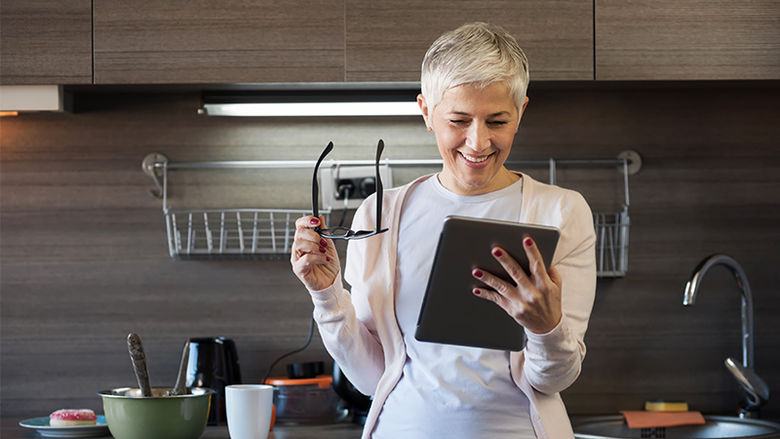 women looking at an ipad smiling