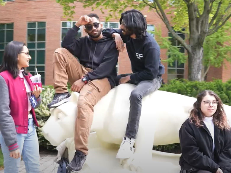 students hanging out around lion shrine