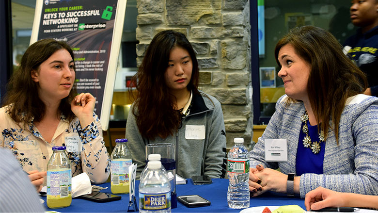 Three people talking at a table 