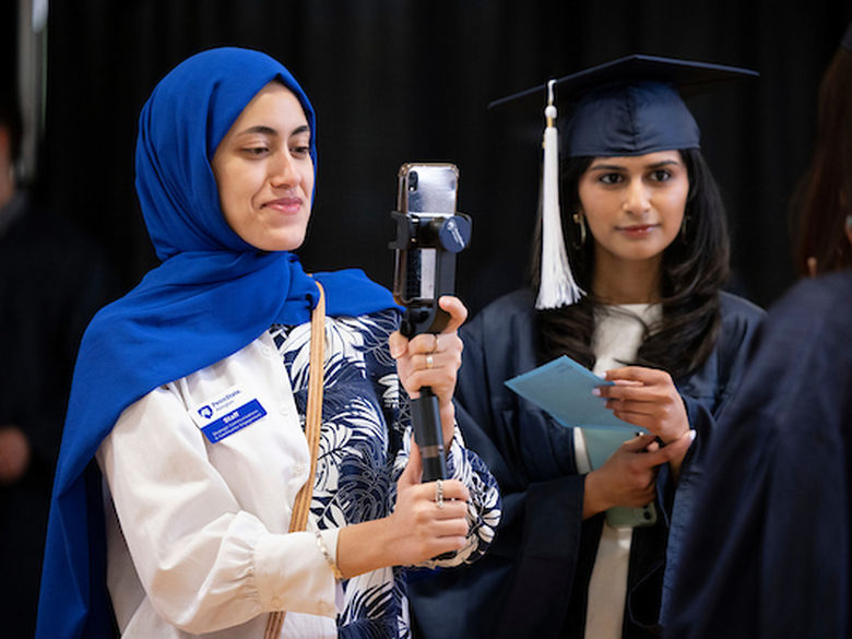 student recording an interview on her phone