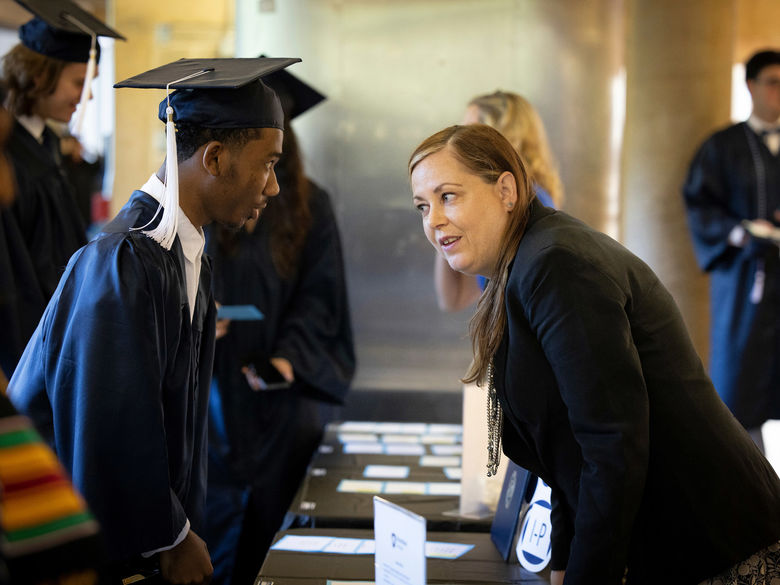 student talking to a staff member