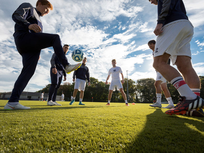 Penn State Abington Men's Soccer Team juggling soccer ball