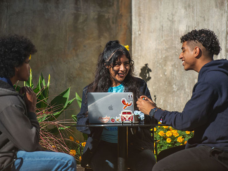 students sitting outside talking