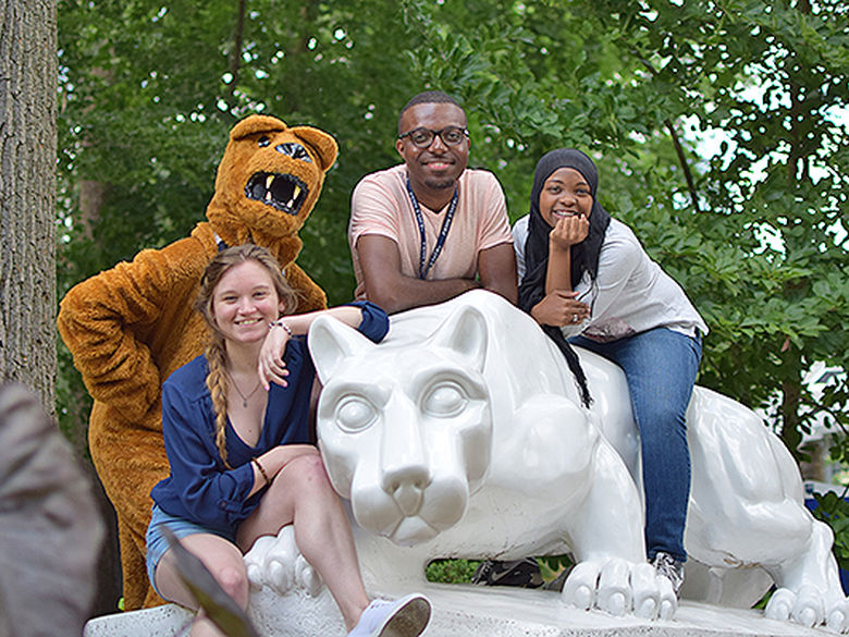 four students on lion shrine