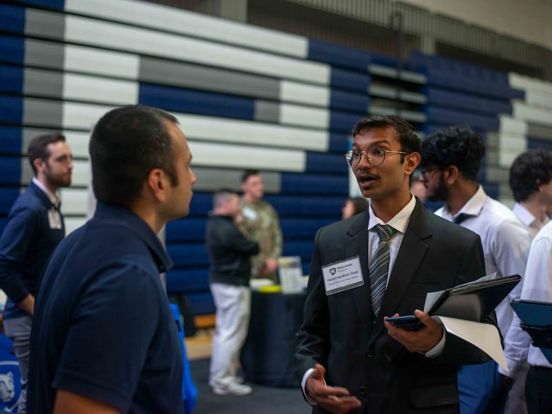 Student talking to employeer at career fair 