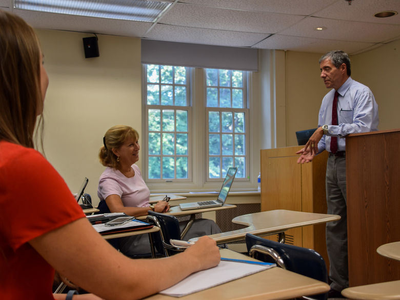 adults listening to speaker in a classroom 