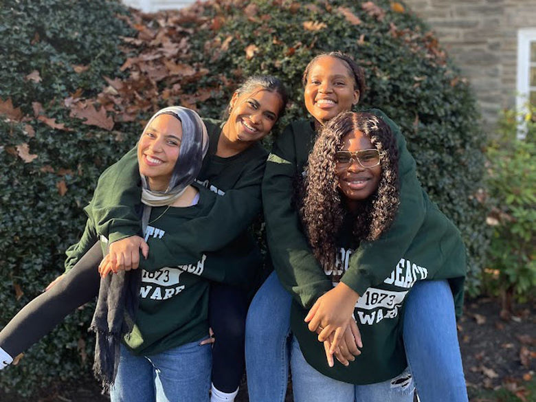 four students smiling 