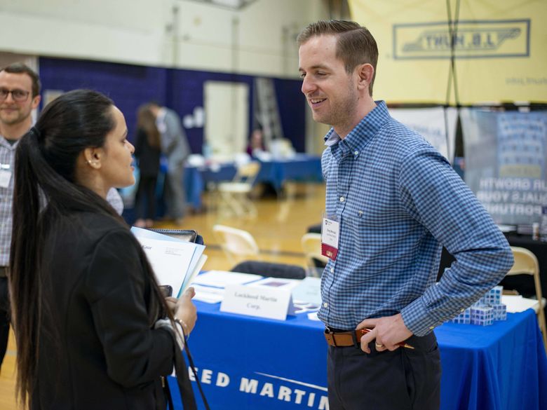 Student at the career fair talking with employer 