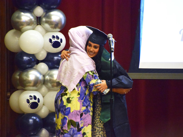 Two students hugging at cultural graduation 