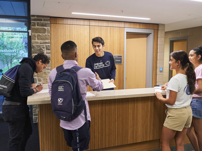Students at front desk of Penn State Abington lions gate near Philadelphia