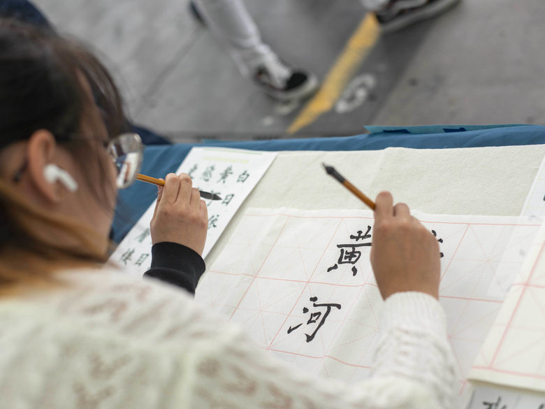 student writing japanese characters