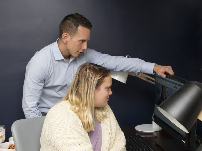 Glenn Sterner with student on computer