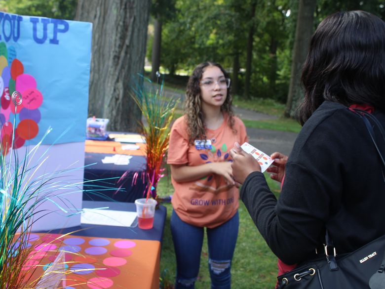 student speaking to another student at open house 