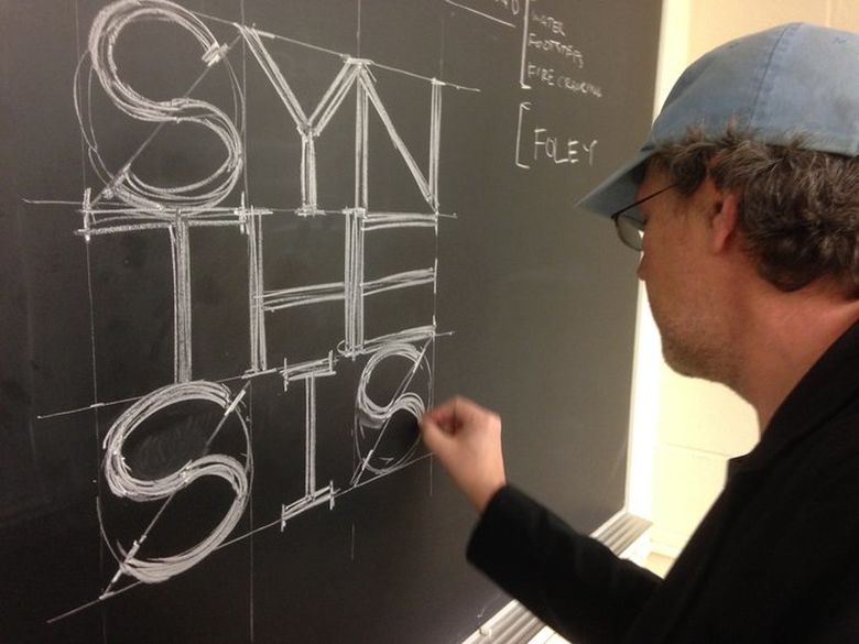 teacher writing on a chalkboard