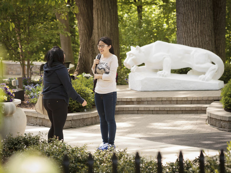 students talking in front of Lion Shrine at Penn State Abington near Philadelphia