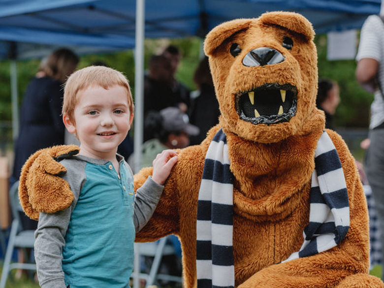 Child posing with nittany lion