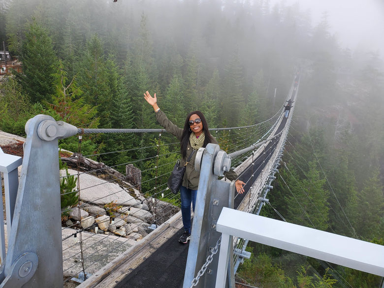 Student standing on a bridge