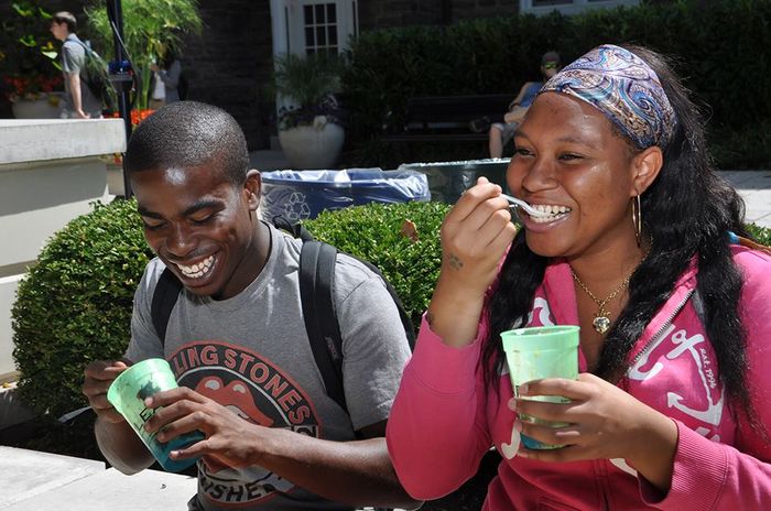 two students eating ice cream and smiling