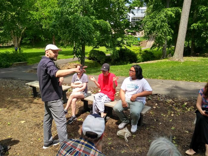 Artist talking to students outside