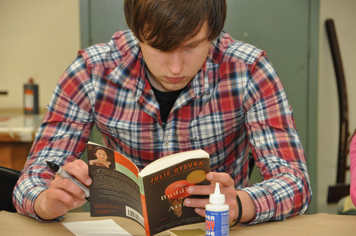 student reading 'Buddha in the Attic'