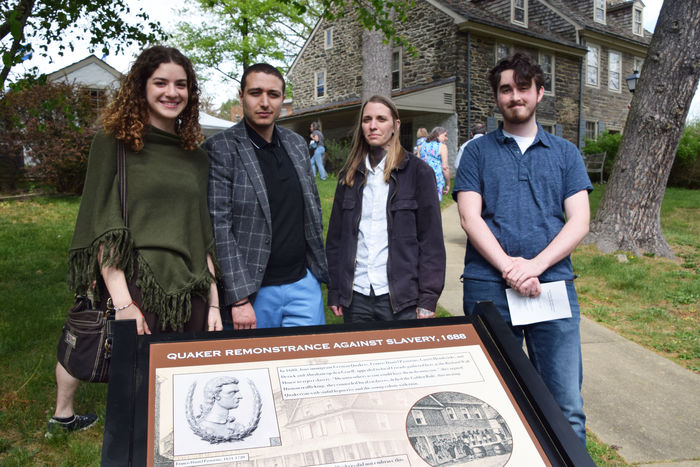 4 public history students standing in front of sign 