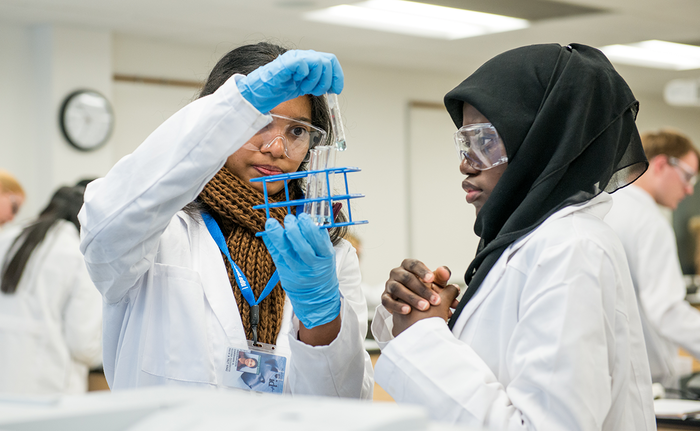 two women in chem lab