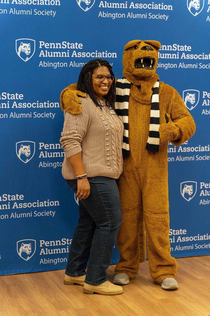 Alumni taking a photo with Nittany Lion