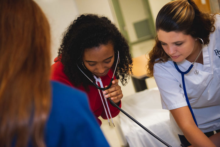 Two student nurses doing an exam