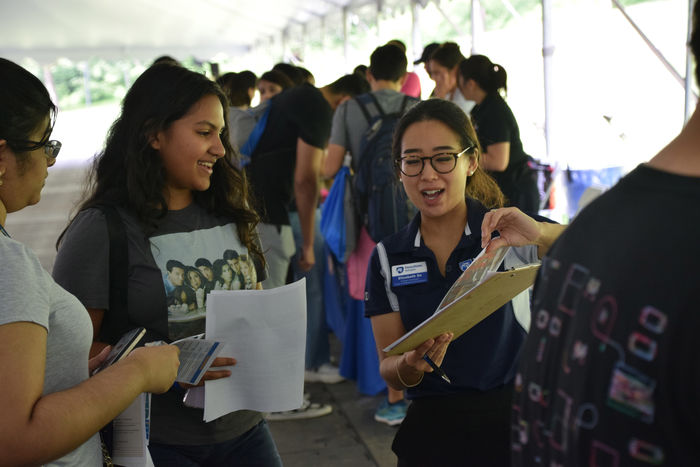 student talking to a staff member 