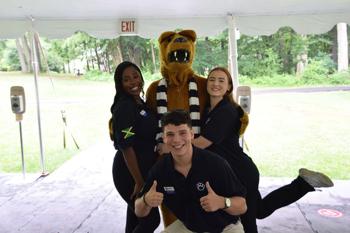 three students posing with Nittany Lion 