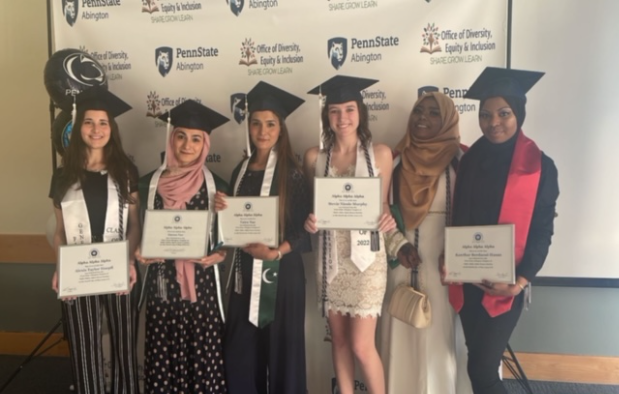 tri-alpha students smiling with grad caps