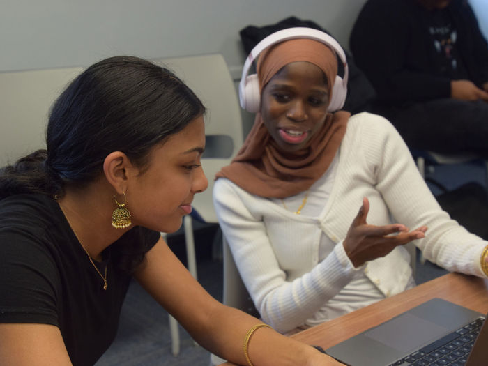 Students collaborating at a laptop