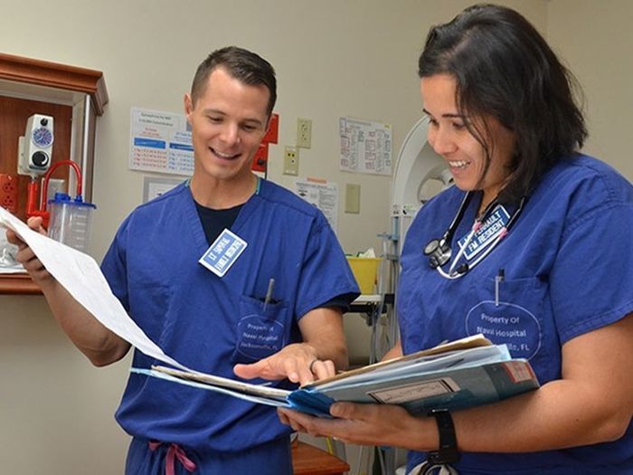 two nurses talking and looking at papers