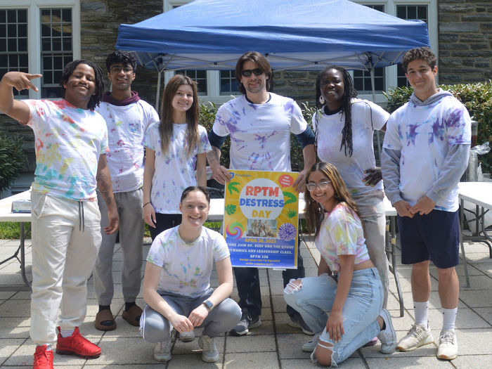 Students in front of a building with a sign