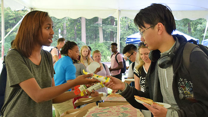 two students sharing pizza