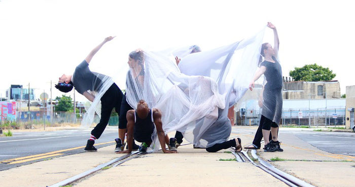 students dancing on train tracks