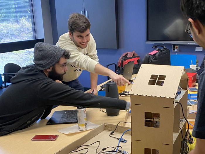 Students in a conference room working on a project