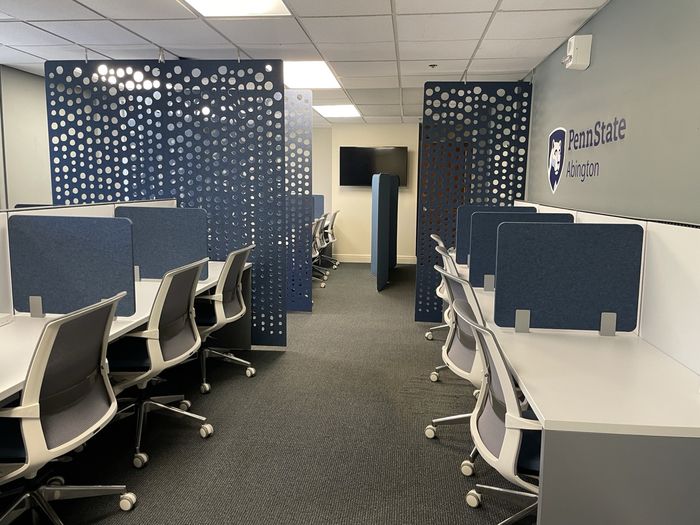 A large room with individual workstations and sound dividers
