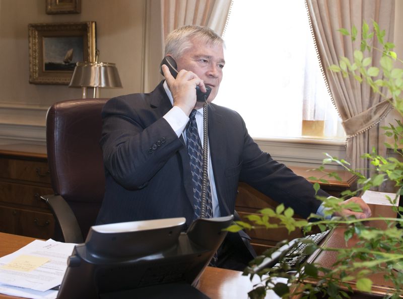 Penn State President Eric Barron on the phone at his desk on May 12.