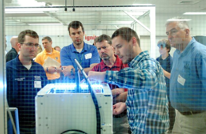 A person demonstrates a 3-D printer at the Innovation Commons