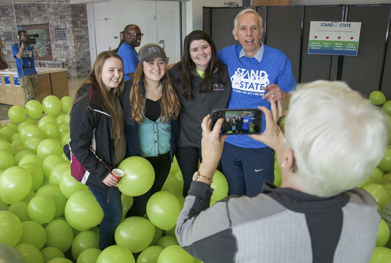 Mike the Mailman posing with students