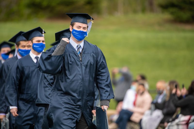 Penn State Behrend graduates celebrate as they leave the stadium at the conclusion of an outdoor ceremony on May 8.