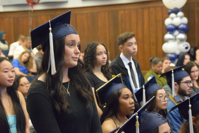 Student standing up during cermony 