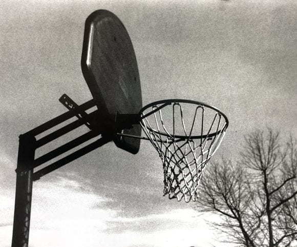 Black and white image of a basketball net