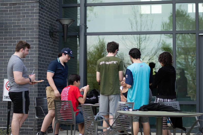 students sitting outside of Lions Gate