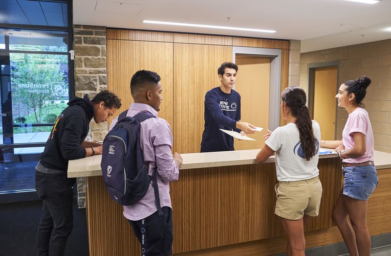 students at the front desk of Penn State Abington lions gate near Philadelphia