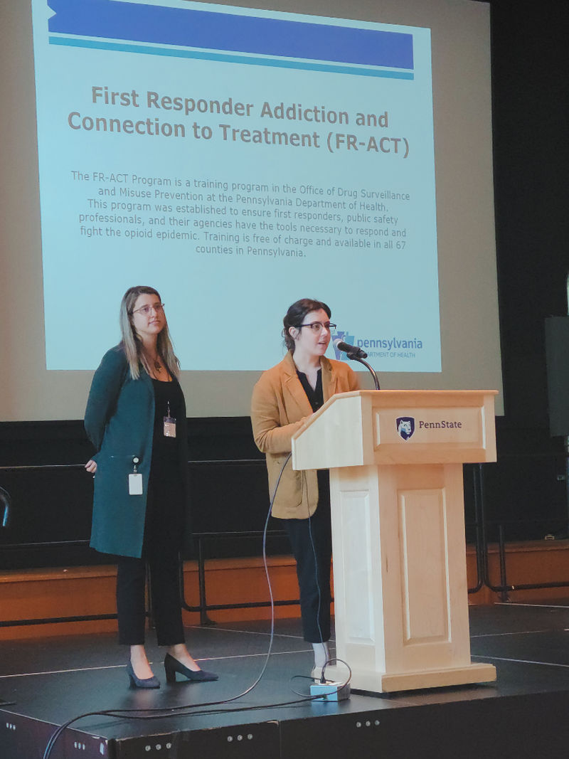 Heather Myers and Zoe Miner presenting at the podium.