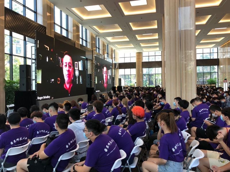 A group of students in a large hall for orientation