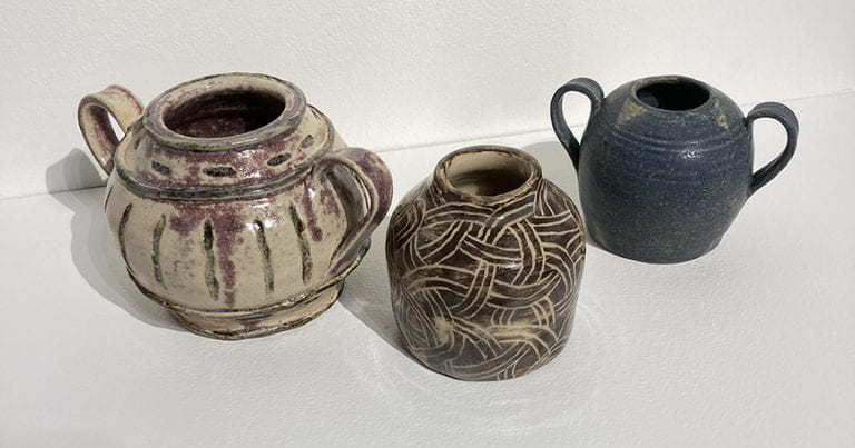 Three ceramic handled pots